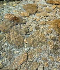 Clean sea water. Pebble beach with transparent water. Relax in summer vacation on tropical island.