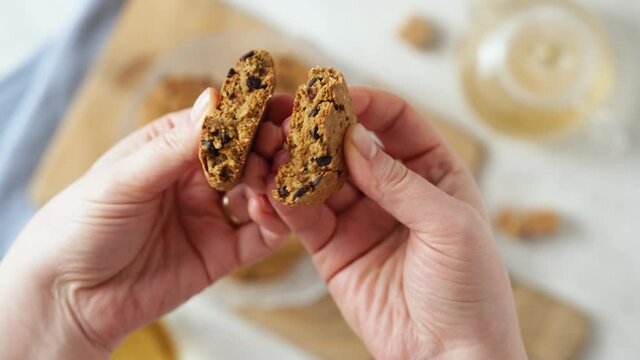 breaking and tasting homemade tea biscuits