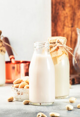 Cashew nut milk in bottles on white background. Non dairy alternative vegan milk. Healthy vegetarian and diet food and drink concept