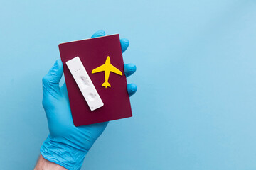 Covid19 travel passport. Person holds lateral antigen test and plane