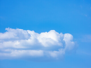 White cumulus clouds on a blue sky background