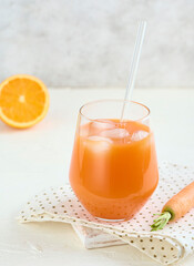 Glass of carrot juice smoothie in lifestyle scene. Copy concept.