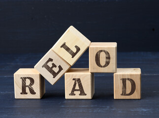 wooden cubes with the inscription reload. The concept of a new beginning in business, relationships.