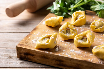 Uncooked pelmeni dumplings on rustic wooden table. typical russian food