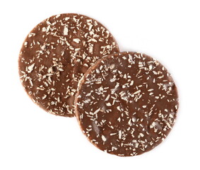 Milk chocolate rice cakes with coconut shavings isolated on white background, top view
