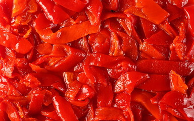 Red pepper, paprika slices with garlic and salty water background and texture