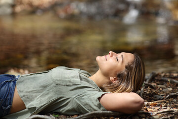 Woman relaxing resting lying in a riverside