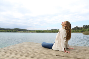 Woman sitting in a pier breathing fresh air