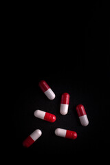 Medical pills on black background