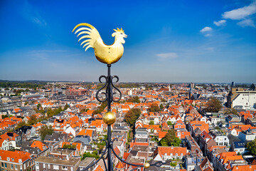 Netherlands, Haarlem - 17-01-2021: Golden rooster on top of church tower of church. © the_lightwriter