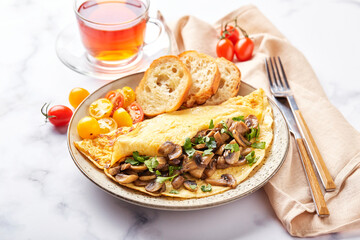 Omelet with champignons and parsley in plate on marble background. Frittata - italian omelet