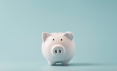 White  piggy bank saving on blue background and copy space ,Money saving for future investment and...