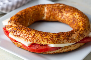 Traditional Turkish breakfast with Turkish bagel with cheese and tomatoes (Turkish name; simit or gevrek)