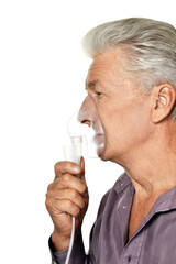 Portrait of  sick senior man with inhaler
