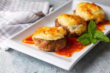 Turkish Food Hasanpasa Kofte - Kofta with Puree - Meatball with Bechamel Sauce and Green Peas. Traditional Food.