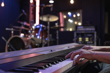 Hands of a musician playing the keys close up.