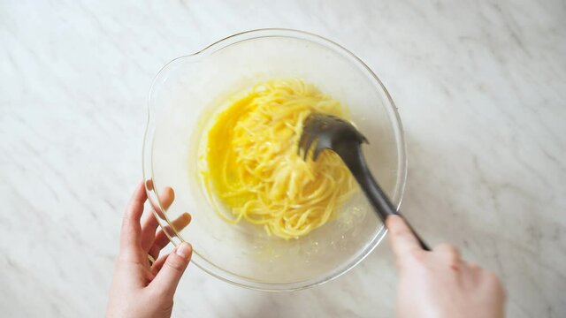 Stirring spaghetti with egg and cheese cream. making italian pasta carbonara
