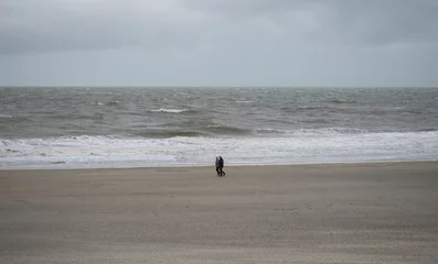  Panorama view of elderly couple walking along sand beach near Westkapelle Domburg Veere Zeeland Netherlands North Sea © Marc