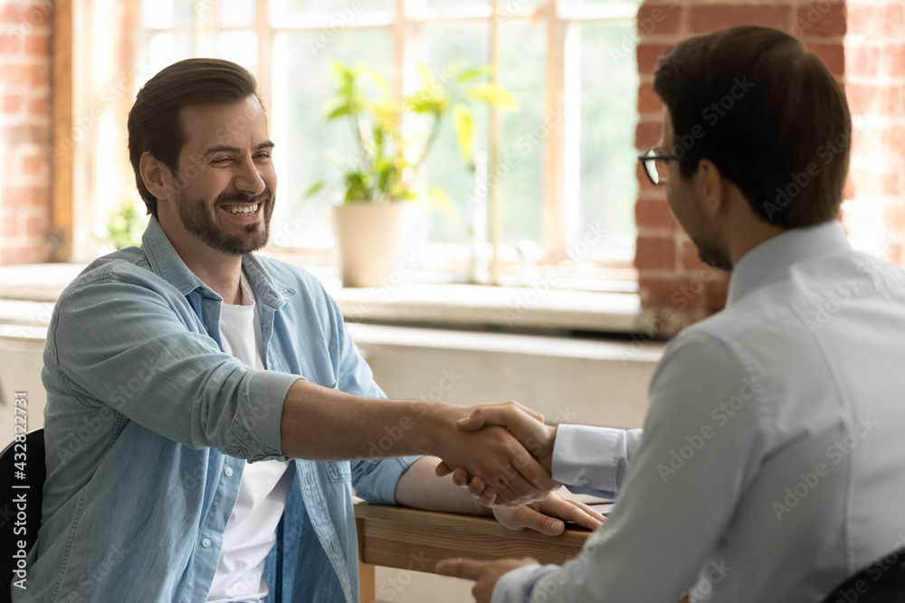 Sticker Hr manager employer shaking happy successful candidate hand at meeting, congratulating with job offer or promotion after interview, business partners handshake at meeting in office, making deal