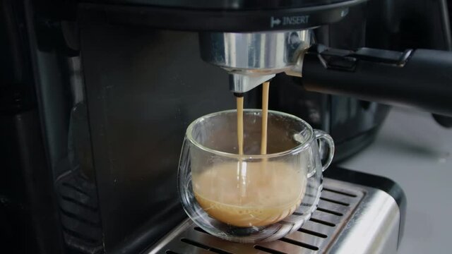 B roll shot of Home maker coffee Pouring coffee into a cup. Make a hot espresso to freshen up. 