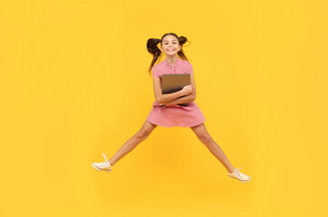 Fototapeta na wymiar happy kid girl jumping with laptop go online shopping, discount