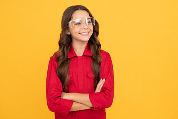 cheerful child girl in glasses and red shirt looking happy, happiness