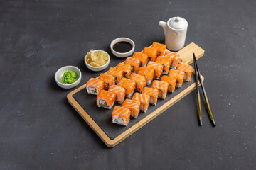 Philadelphia Sushi Roll made of Fresh Salmon, Avocado and Cream Cheese inside. Traditional Japanese cuisine. Asian food