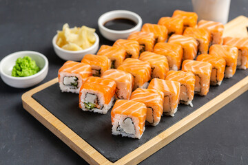 Philadelphia Sushi Roll made of Fresh Salmon, Avocado and Cream Cheese inside. Traditional Japanese cuisine. Asian food
