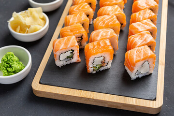 Philadelphia Sushi Roll made of Fresh Salmon, Avocado and Cream Cheese inside. Traditional Japanese cuisine. Asian food