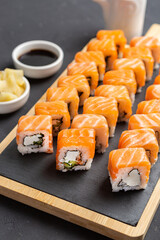 Philadelphia Sushi Roll made of Fresh Salmon, Avocado and Cream Cheese inside. Traditional Japanese cuisine. Asian food