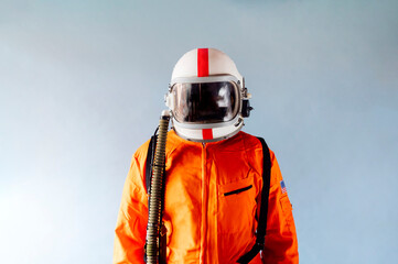 Unrecognizable man in orange astronaut suit.