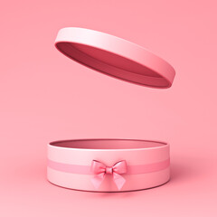 Blank open pink round gift box or cylinder present box with pink ribbon bow isolated on light pink orange pastel color background with shadow minimal conceptual 3D rendering