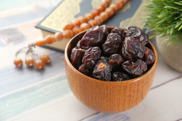 Holy book Quran and rosary on table, close up.