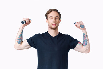 Fototapeta na wymiar man with pumped up muscles of arms and dumbbells black t-shirt white background