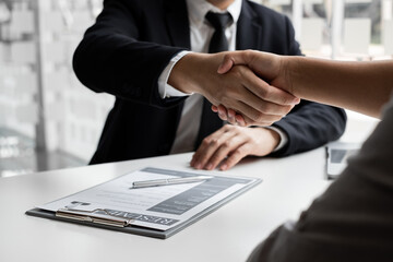 Business owners making handshake with job applicants to agree employ.