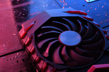 Computer game graphics card, videocard with two coolers on circuit board ,motherboard background....
