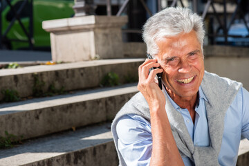 horizontal portrait happy older man talking with mobile phone