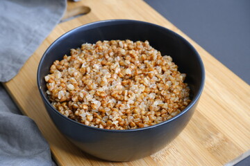 Buckwheat porridge on a black background. Tasty food. Cooking.