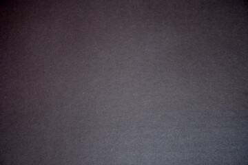 Stylish black background. The texture of the cardboard.