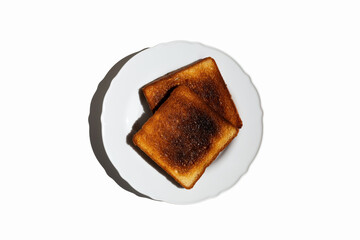 two burnt toast on a white plate on a white background