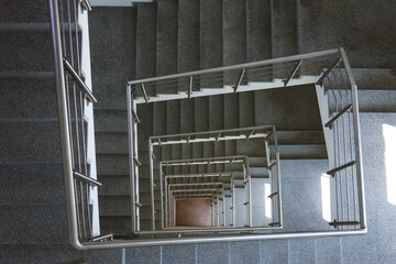 piral stairwell going down a multiple flights. 