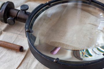 Group of old vintage retro loupes magnifier on canvas top view, searching concept