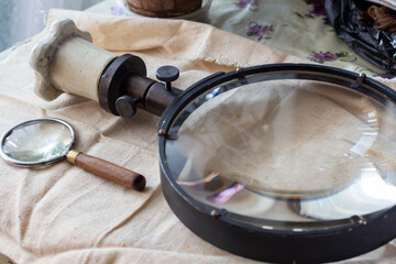 Group of old vintage retro loupes magnifier on canvas top view, searching concept