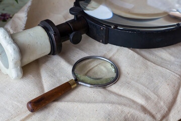 Group of old vintage retro loupes magnifier on canvas top view, searching concept