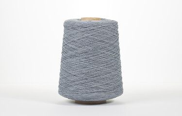 Bobbin of yarn on a white background. Side view. Textile spool on an isolated white background....