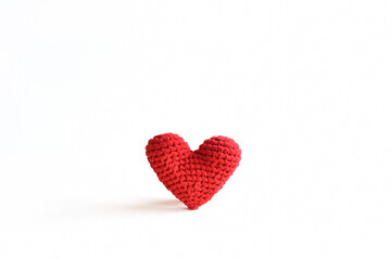 Handmade red crochet heart on white background