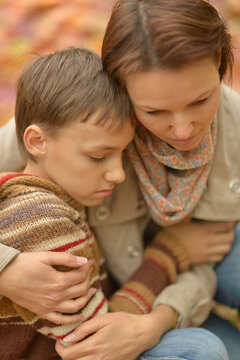  Close Up Portrait Of Sad  Mother With Son  In Autumnal Park