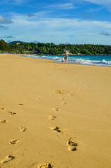 Foot prints on the beach sand. Flight vacation concept.