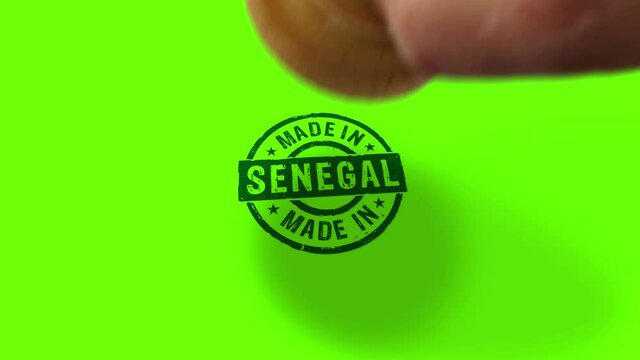 Made in Senegal stamp and hand stamping impact isolated animation. Factory, manufacturing and production country 3D rendered concept. Alpha matte channel.