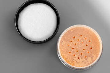 Open loose powder container on table close up